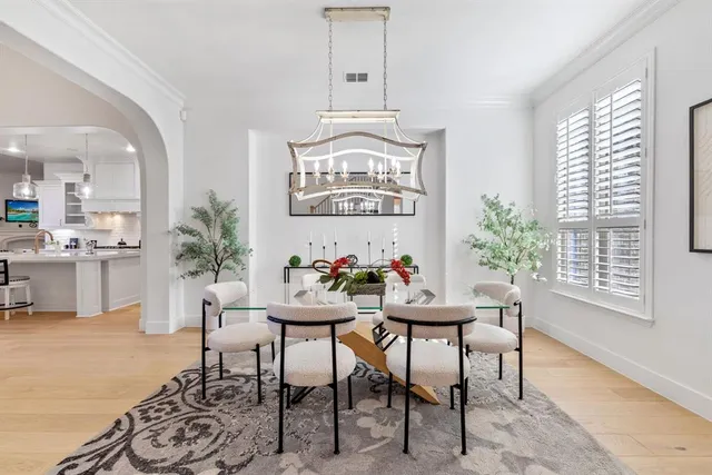 a view of a dining room with furniture and a chandelier