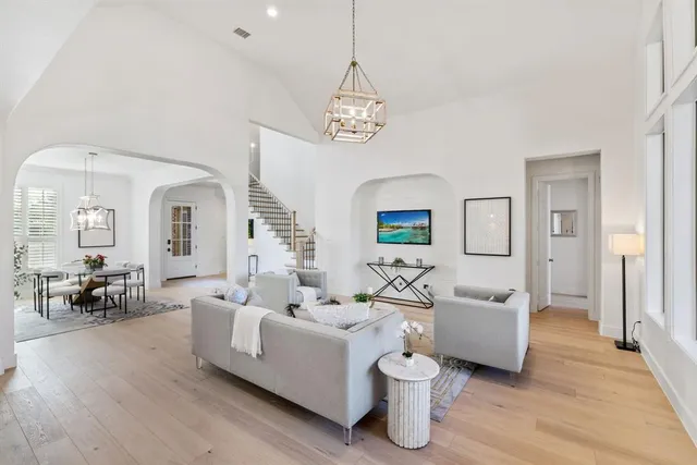 a living room with furniture and wooden floor