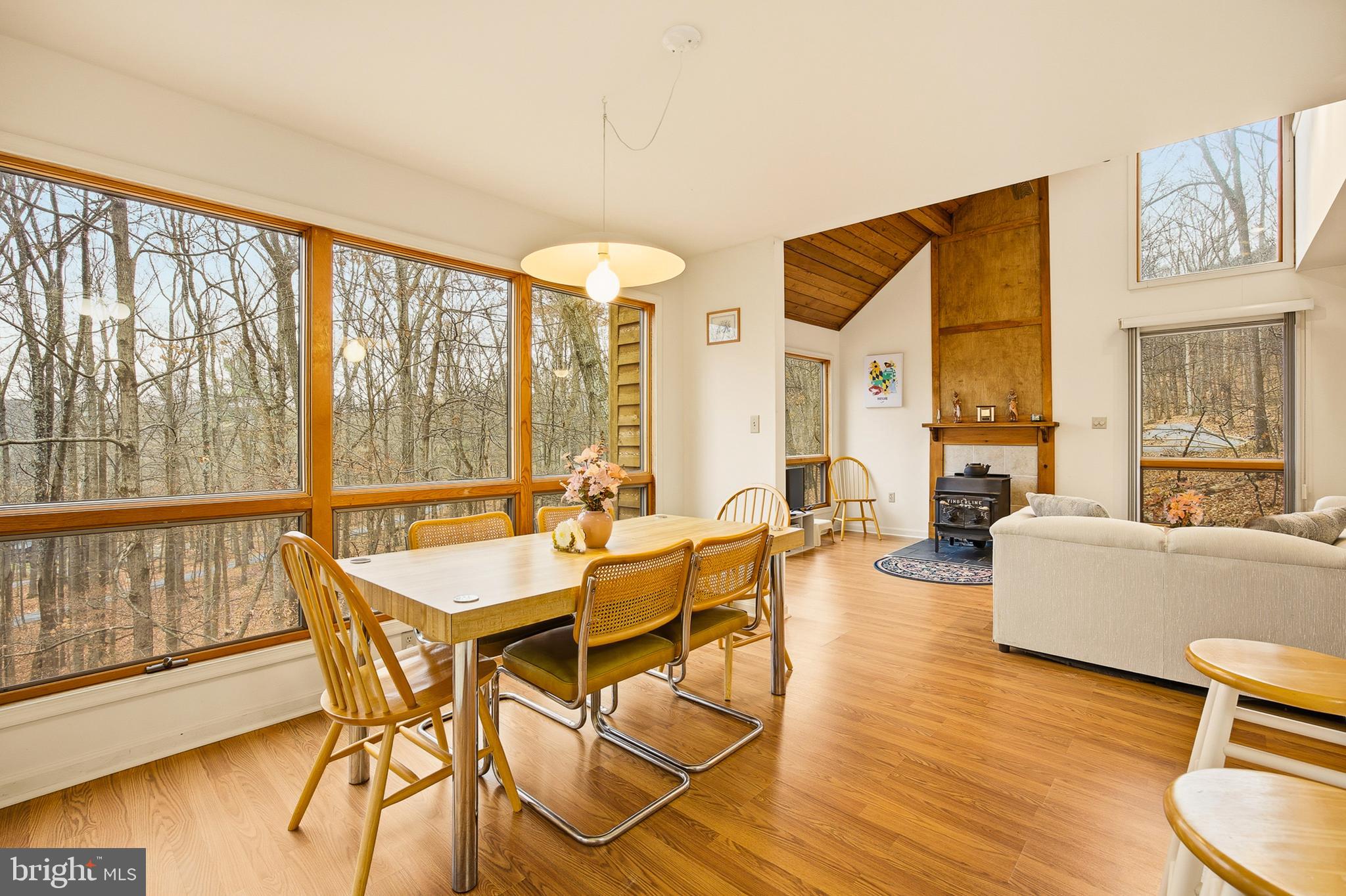 16 Gopher Trail Berkeley Springs, WV 25411 - Photo 13 of 52 a dining room with wooden floor and windows