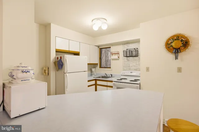 a kitchen with stainless steel appliances a refrigerator and a stove top oven