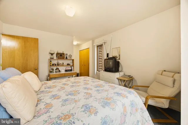 a bedroom with a bed and a couch