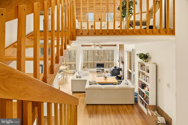 a living room with large windows and furniture