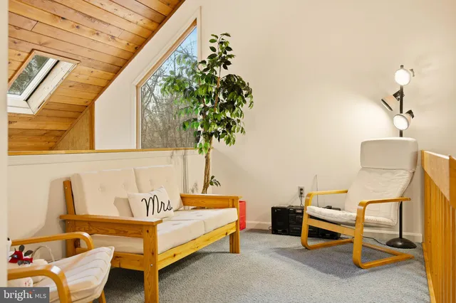 a bedroom with furniture and a potted plant