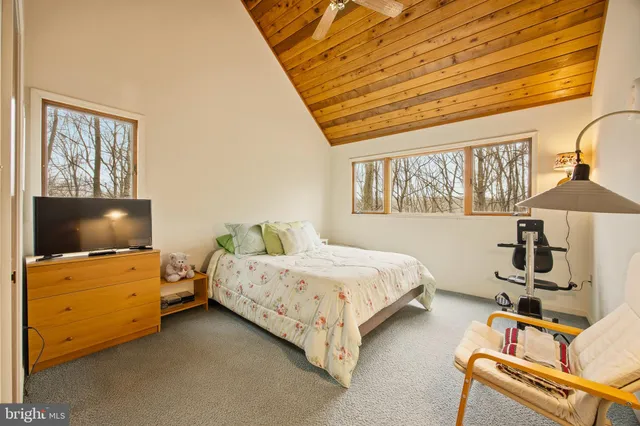 a bedroom with bed and wooden floor