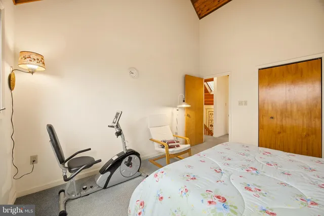 a bedroom with a bed and a couch