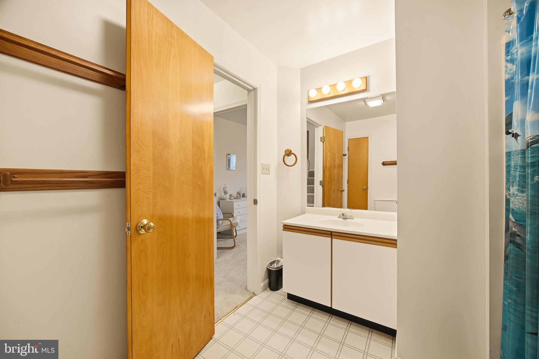 16 Gopher Trail Berkeley Springs, WV 25411 - Photo 42 of 52 a bathroom with a granite countertop sink and a mirror