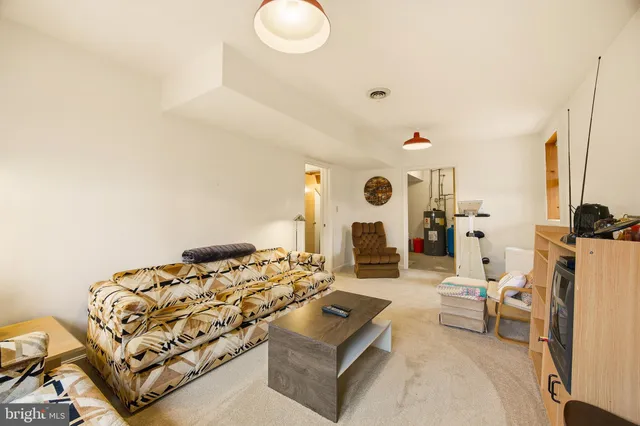 a living room with furniture windows and a flat screen tv