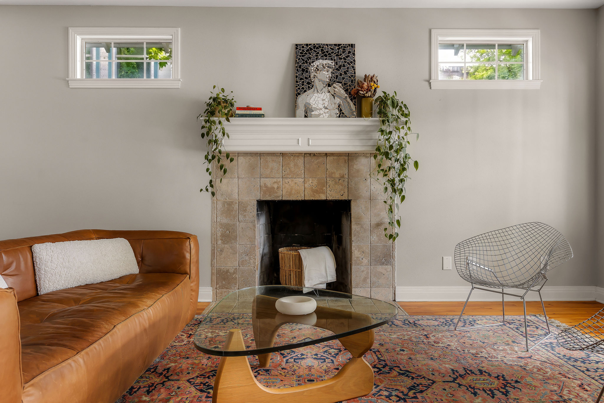 5108 Eilers Avenue Austin, TX 78751 - Photo 25 of 39 A sun-filled living area featuring a cozy fireplace and rich hardwood flooring.
