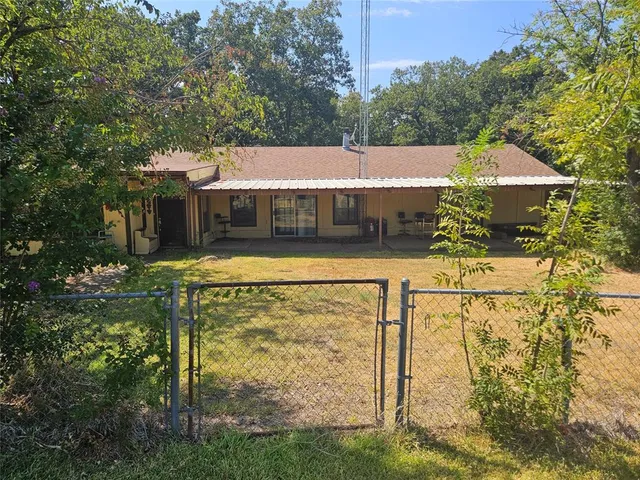 a view of house with yard swimming pool and outdoor seating