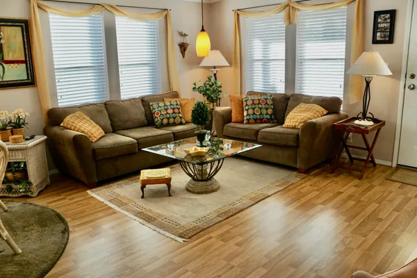 a living room with furniture and a lamp
