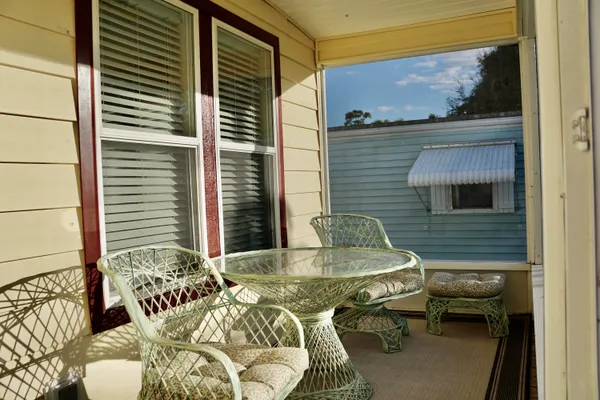 a balcony with table and chairs
