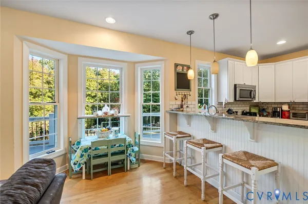 a dinning room filled with furniture and large windows