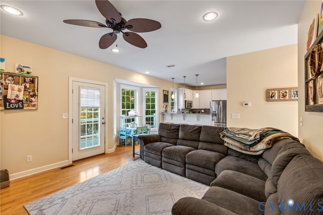 338 Thessalonia Road Bremo Bluff, VA 23022 - Photo 16 of 50 a living room with furniture ceiling fan and a rug