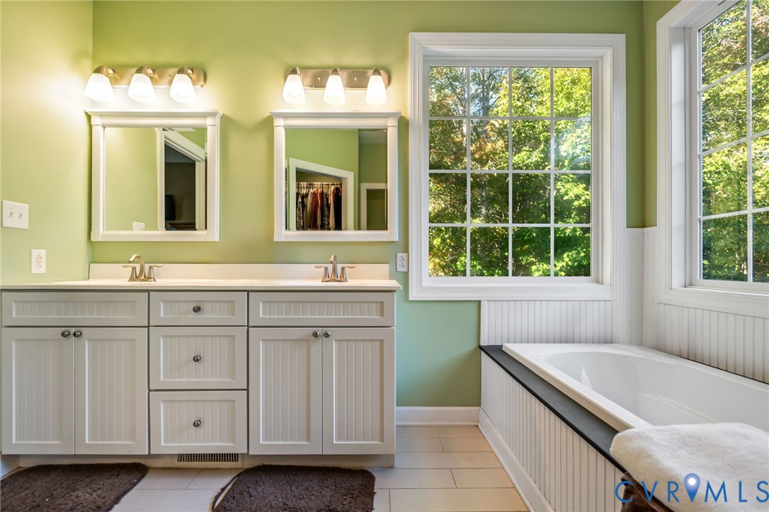 338 Thessalonia Road Bremo Bluff, VA 23022 - Photo 20 of 50 a bathroom with a granite countertop tub and a sink