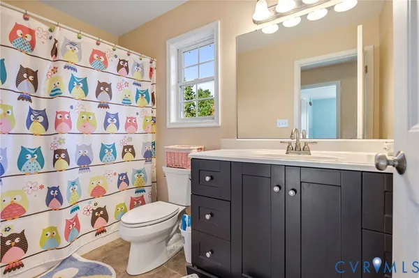 a bathroom with a toilet a sink and a large mirror