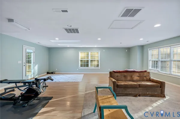a living room with furniture a window and gym equipment