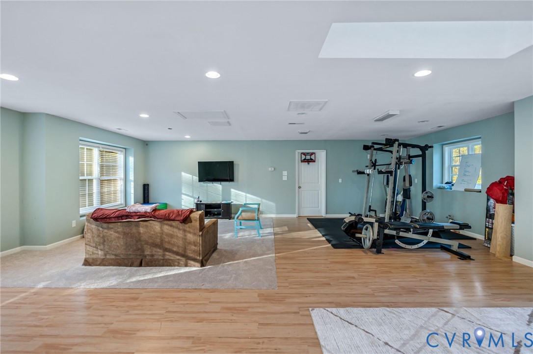 338 Thessalonia Road Bremo Bluff, VA 23022 - Photo 36 of 50 a living room with furniture gym equipment and a flat screen tv