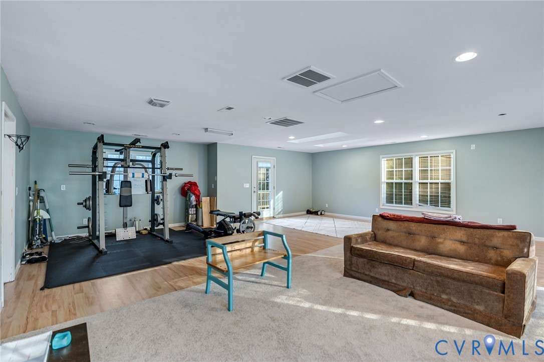 338 Thessalonia Road Bremo Bluff, VA 23022 - Photo 39 of 50 a living room with furniture a window and gym equipment