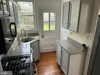 a kitchen with a sink stove and refrigerator