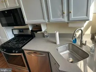 a kitchen with sink and cabinets