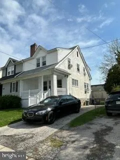 a view of a car parked in front of a house