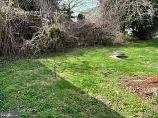 a backyard of a house with lots of green space and garden
