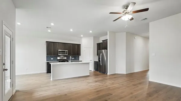 a kitchen with stainless steel appliances a refrigerator and a microwave