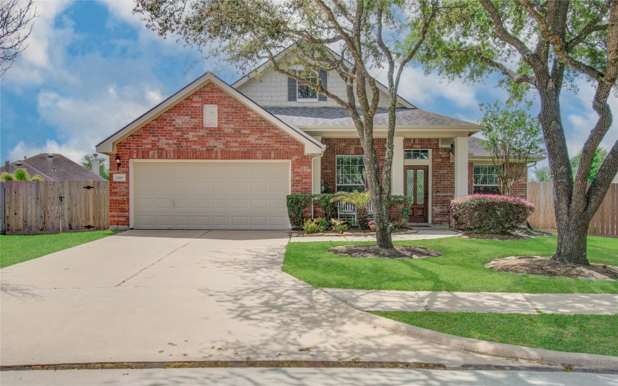 20007 Alcea Court Spring, TX 77379 - Photo 1 of 43 Charming brick home with a spacious front yard and mature trees. Features a two-car garage, inviting front porch, and well-maintained landscaping. Ideal for family living.