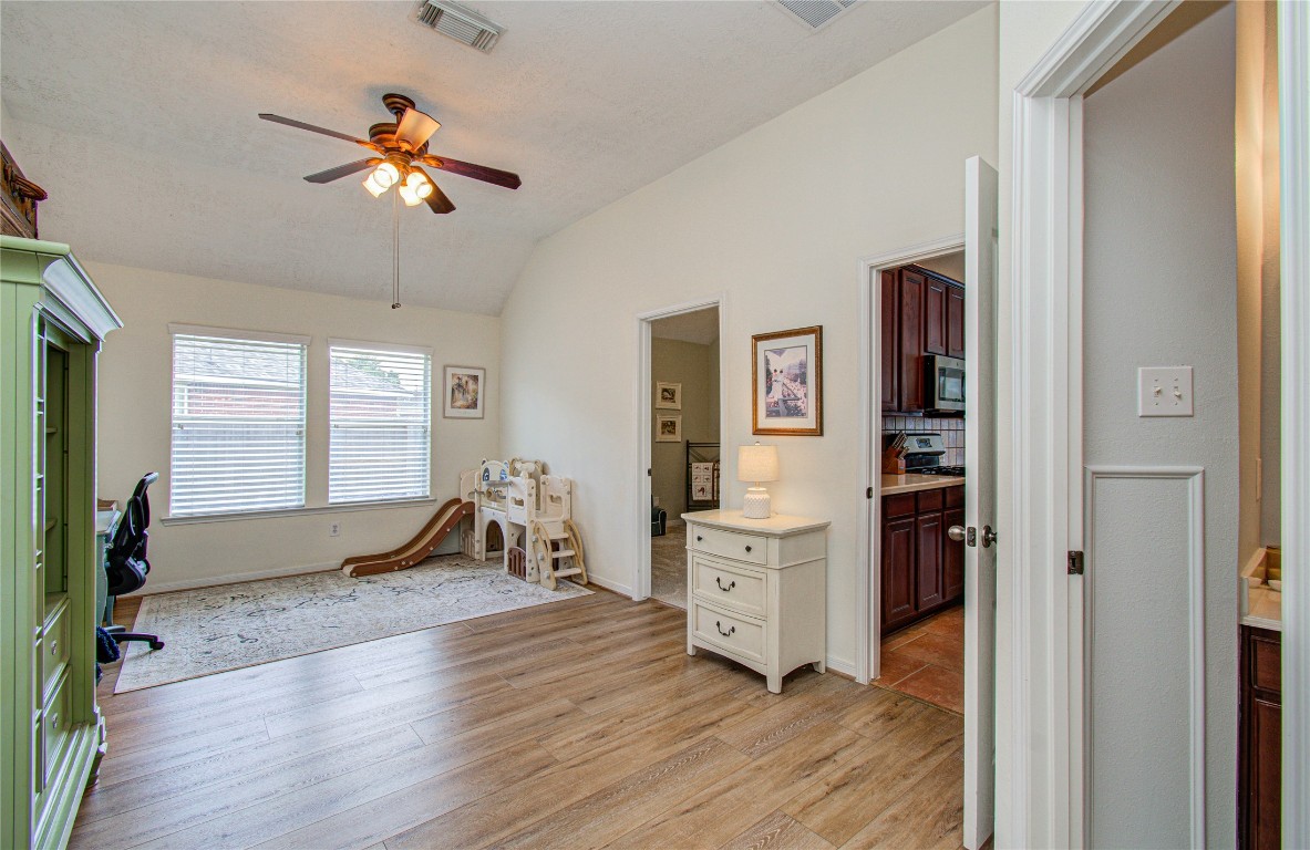 20007 Alcea Court Spring, TX 77379 - Photo 12 of 43 This open den can be used as a home office or additional room. It connects to a kitchen with rich cabinetry and a cozy play area, making it perfect for family living.