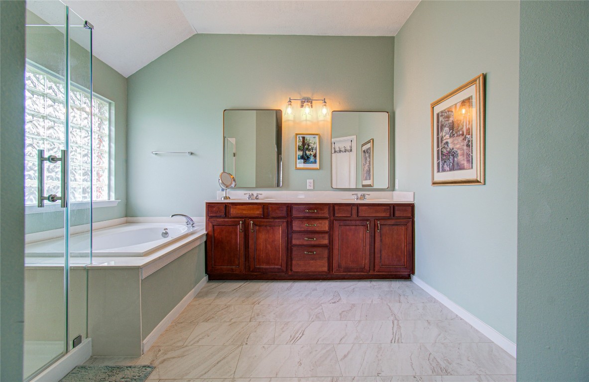 20007 Alcea Court Spring, TX 77379 - Photo 36 of 43 Primary bathroom features double sinks with separate tub and shower.