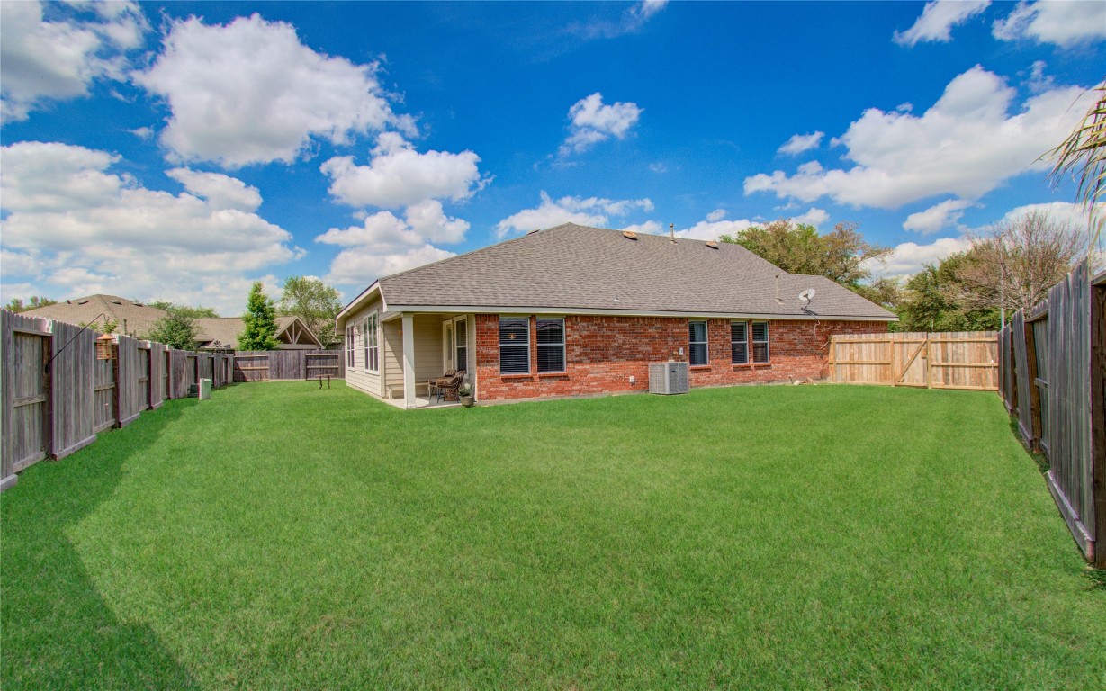 20007 Alcea Court Spring, TX 77379 - Photo 40 of 43 Large backyard with covered patio perfect for relaxing evenings.