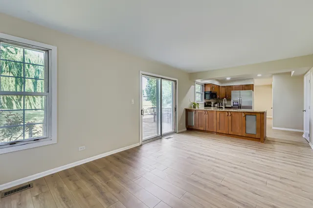a view of a kitchen with furniture and wooden floor