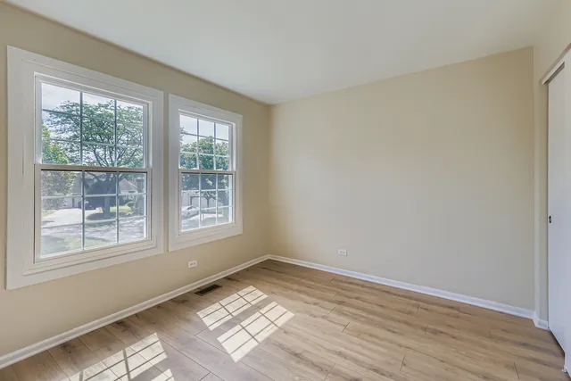 a view of wooden floor and windows in a room