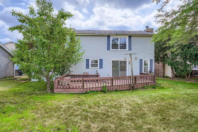 a view of a house with a yard and sitting area