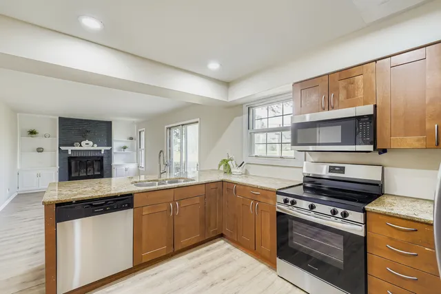 a kitchen with stainless steel appliances a stove sink and microwave