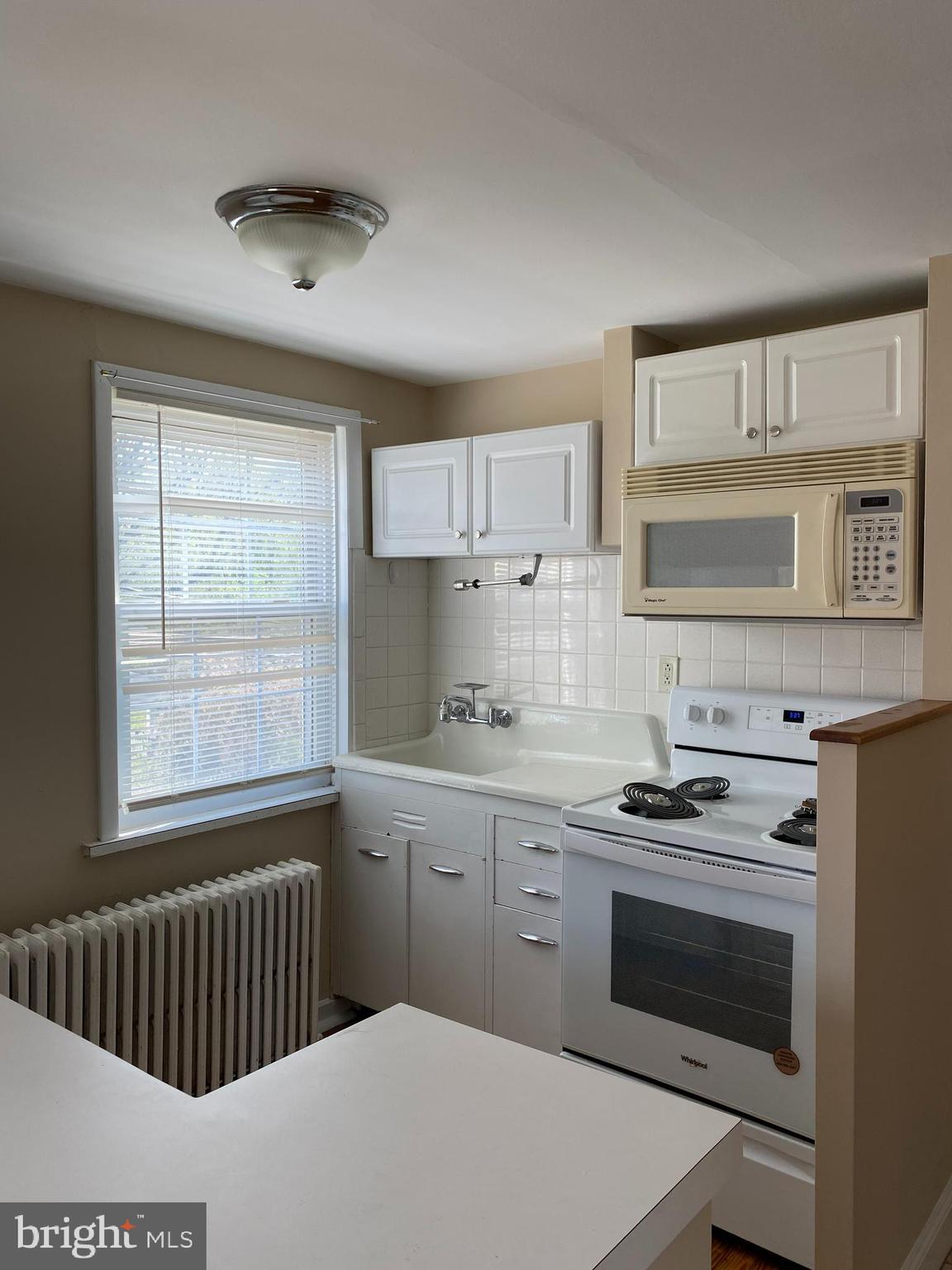 2185 Kimberton Road Phoenixville, PA 19460 - Photo 4 of 15 a kitchen with stainless steel appliances a stove sink and cabinets