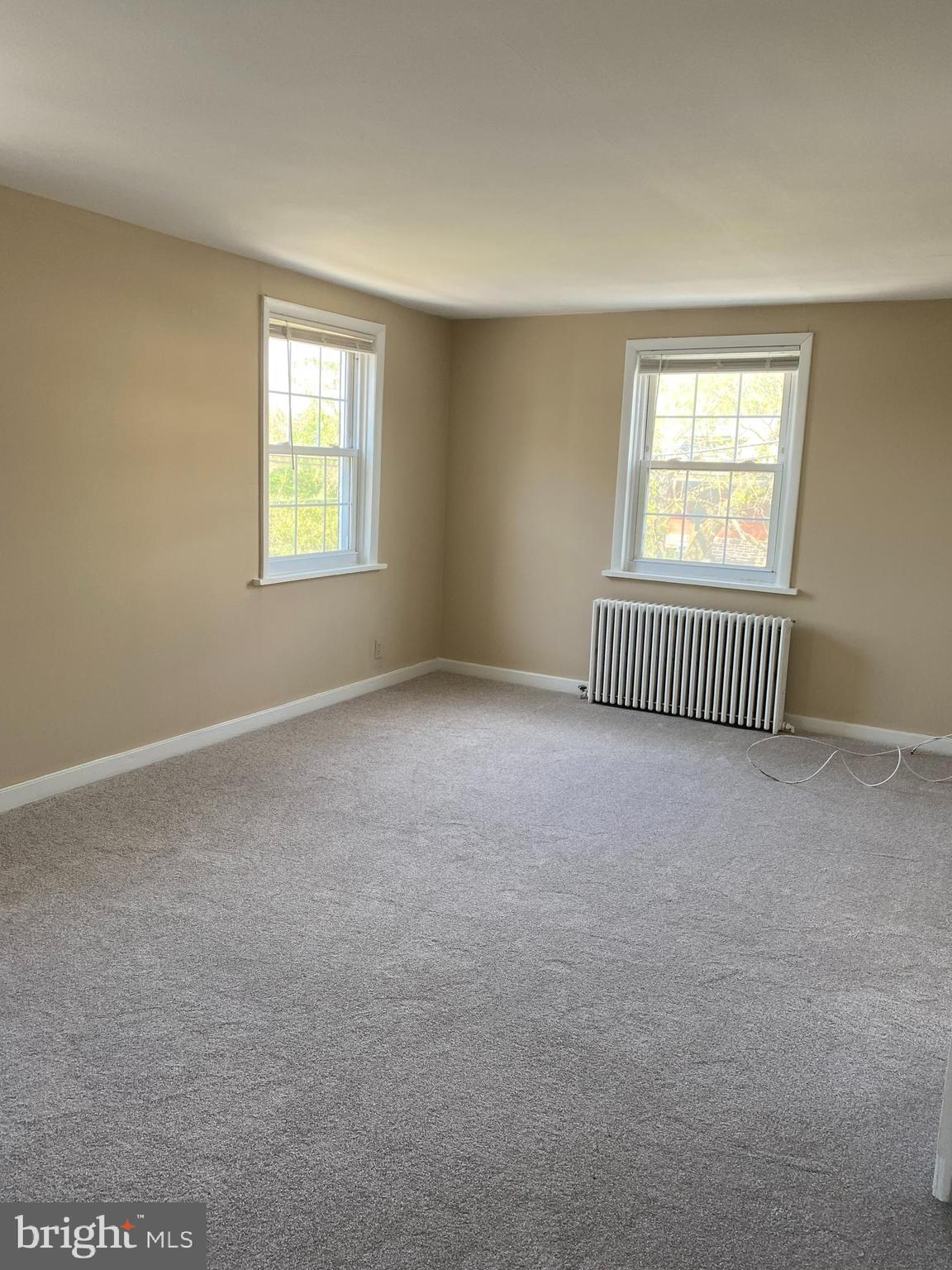 2185 Kimberton Road Phoenixville, PA 19460 - Photo 8 of 15 an empty room with floor to ceiling window and chandelier