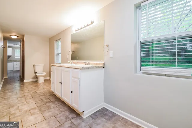 a view of a bathroom with a sink and a mirror