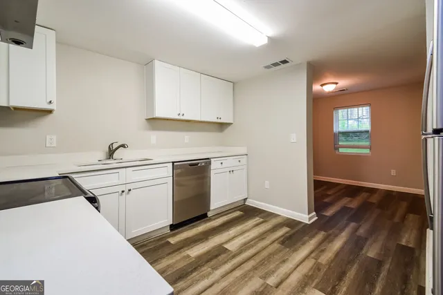 a kitchen with a sink stove and cabinets