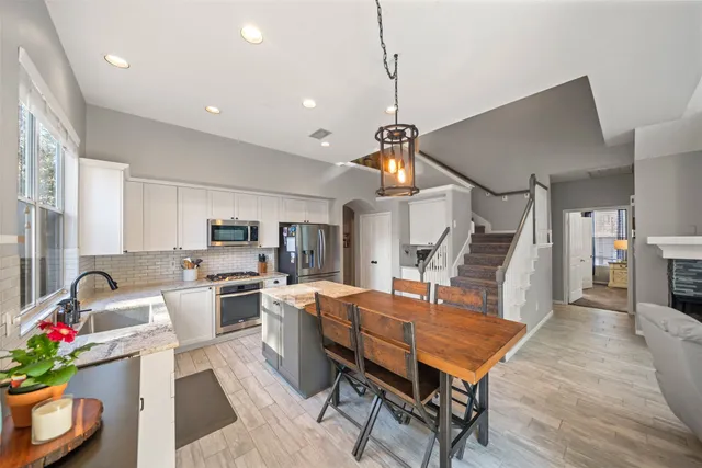 a living room with furniture a piano and a chandelier
