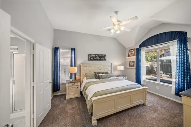 a bedroom with a bed and a large window