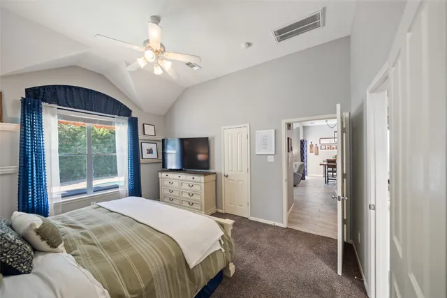 a bedroom with a large bed and a large window