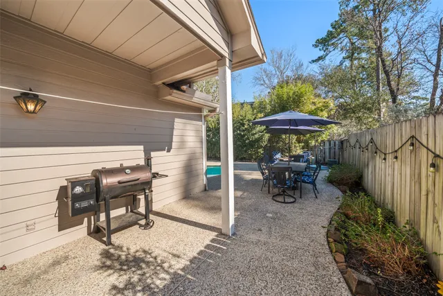 a view of a chairs and table under an umbrella in patio