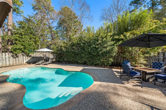 a view of a swimming pool with chairs