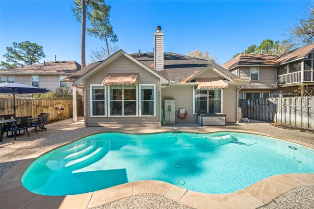 a view of a house with swimming pool and porch