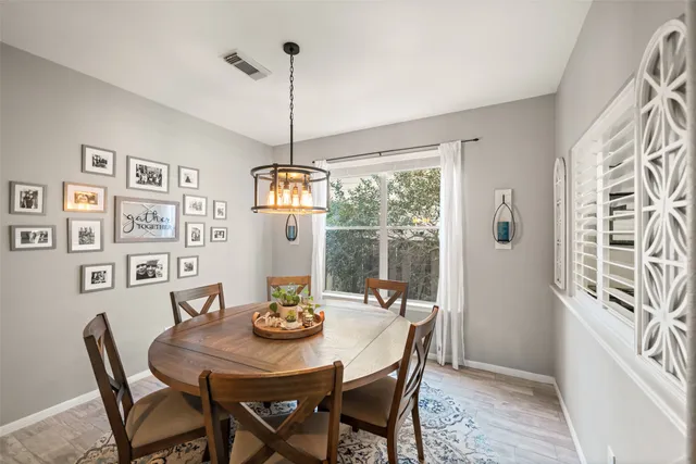 a view of a dining room with furniture window and wooden floor