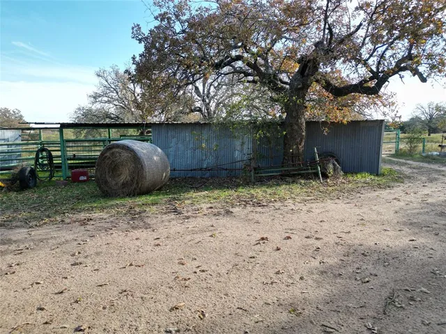 a kitchen with stainless steel appliances granite countertop a stove a sink dishwasher and a refrigerator with wooden cabinets
