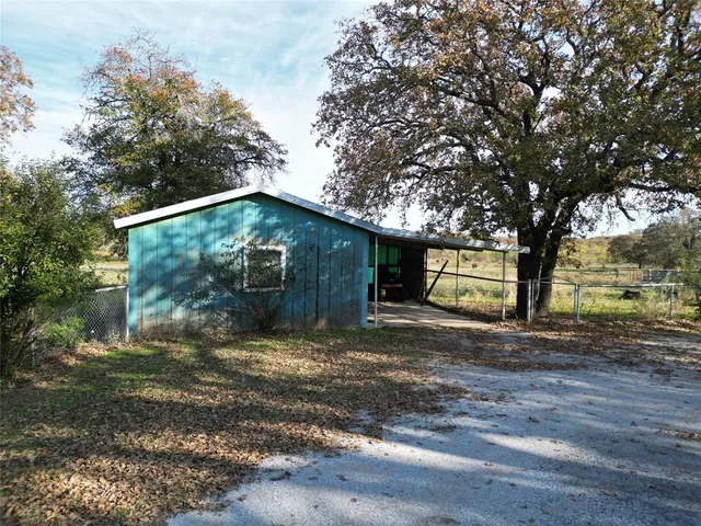 a tree in front of a white house