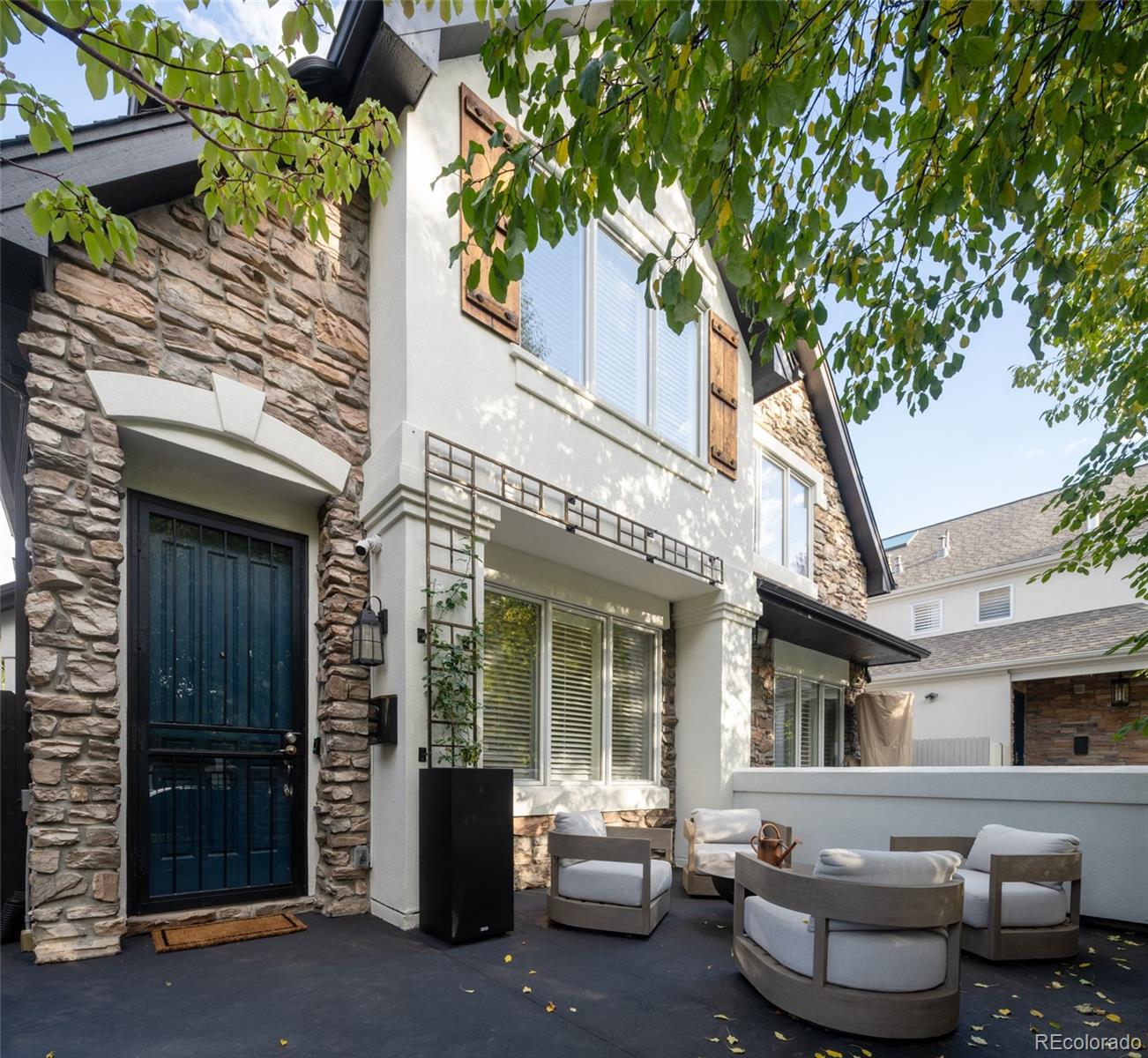 538 Madison Street Denver, CO 80206 - Photo 3 of 12 a view of a patio with couches table and chairs and potted plants