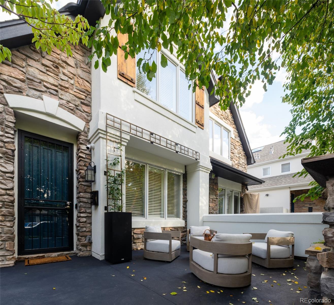 538 Madison Street Denver, CO 80206 - Photo 5 of 12 a view of a patio with couches and table and chairs and potted plants